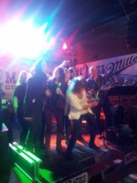 a group of people standing on stage at a nightclub
