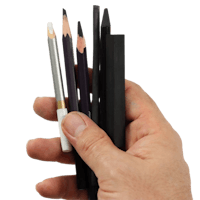 a hand holding several pencils and a pencil sharpener