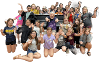 a group of young people posing for a photo with a piano